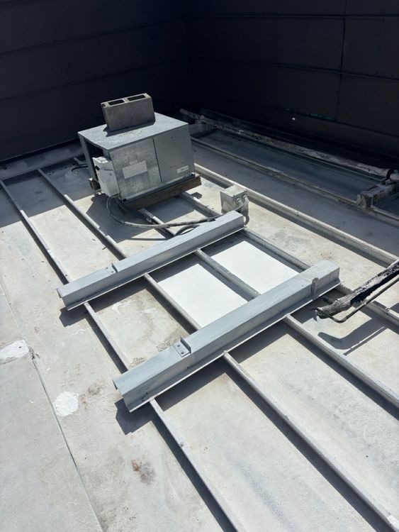 Support framing and surrounding metal panels within the work area.