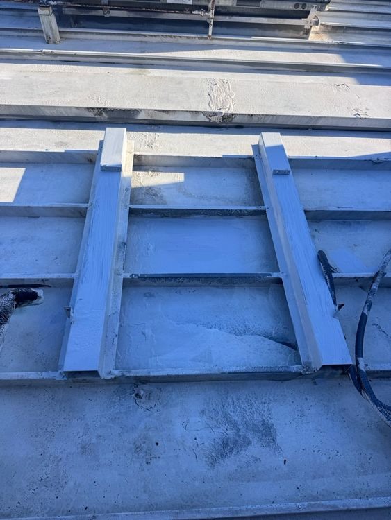 Roof treatment within and around an equipment-support frame.